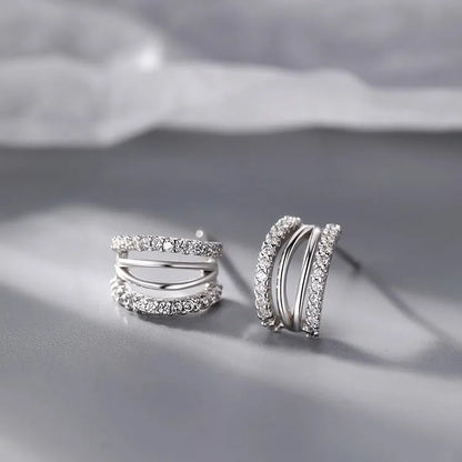 A pair of geometric-shaped 925 sterling silver earrings with a polished finish on a white background.