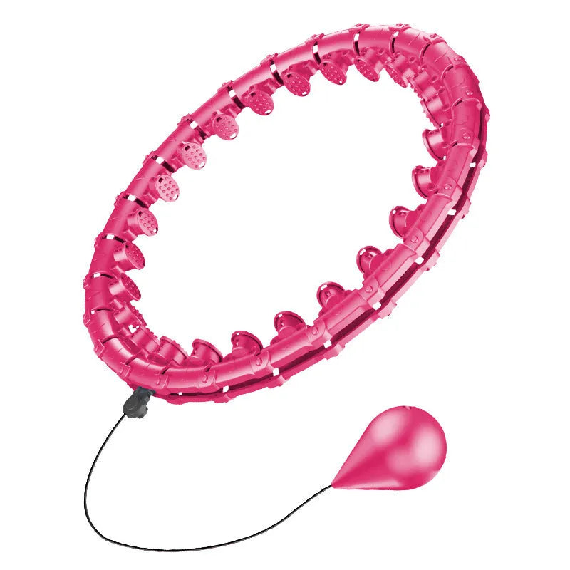 Pink massage soft ball with a detachable black belt, shown on a fitness mat.