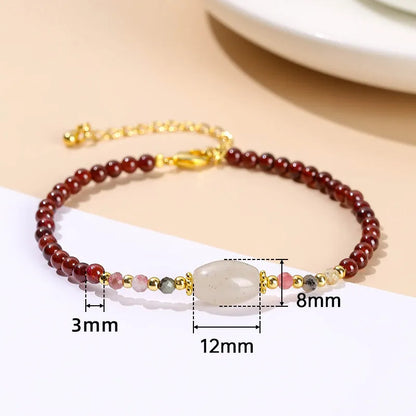 Close-up of a manually crafted crystal agate bracelet with shaped animal and fruit beads.