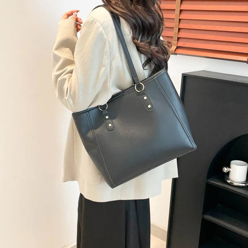 Horizontal square tote bag in black with contrast colour accents showing internal mobile phone pocket and document compartment