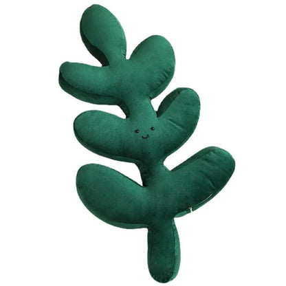 Green embroidered plant cushion with monstera leaf pattern on plush fabric