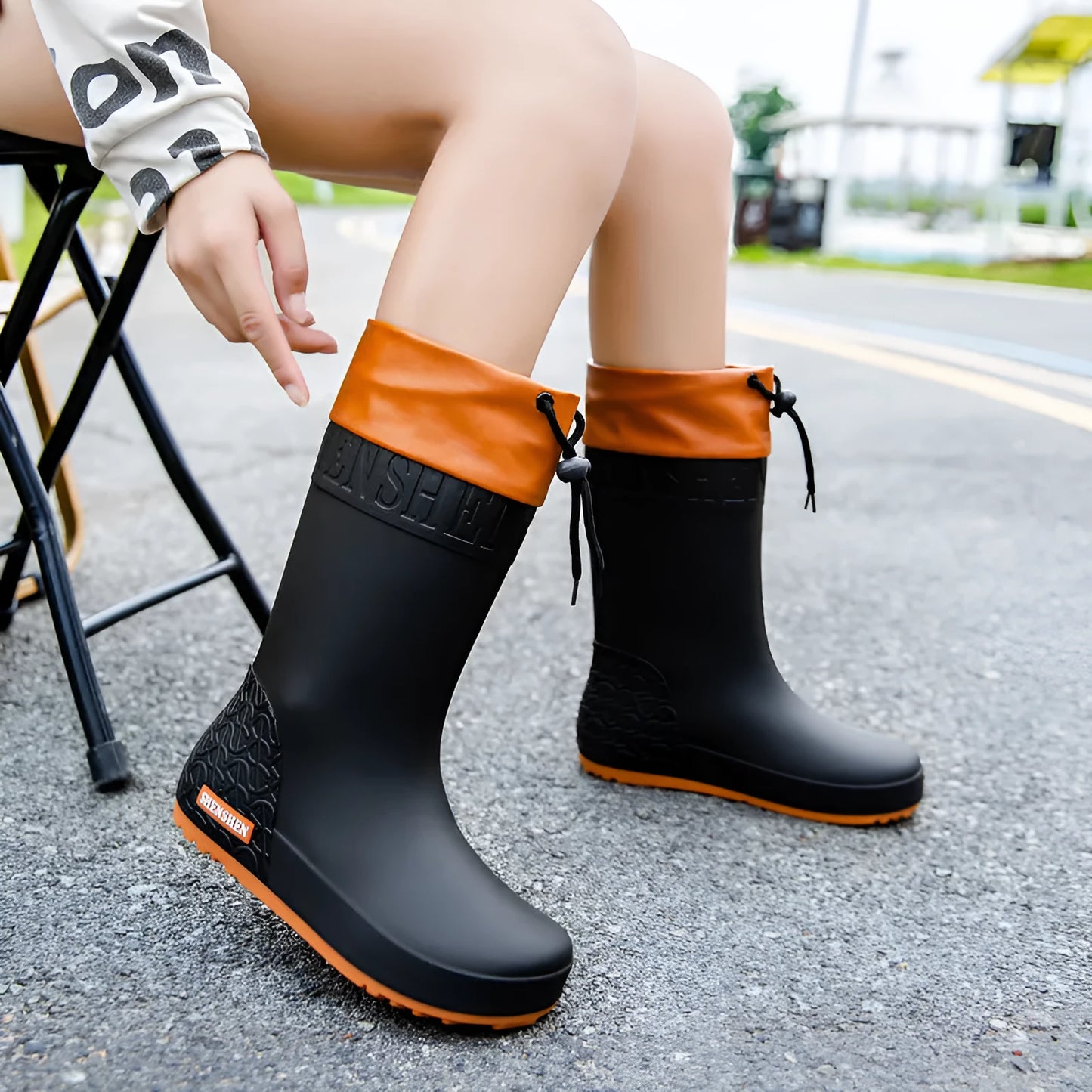 Women's solid colour PVC rain boots with non-slip soles in apricot, black, brown, or pink