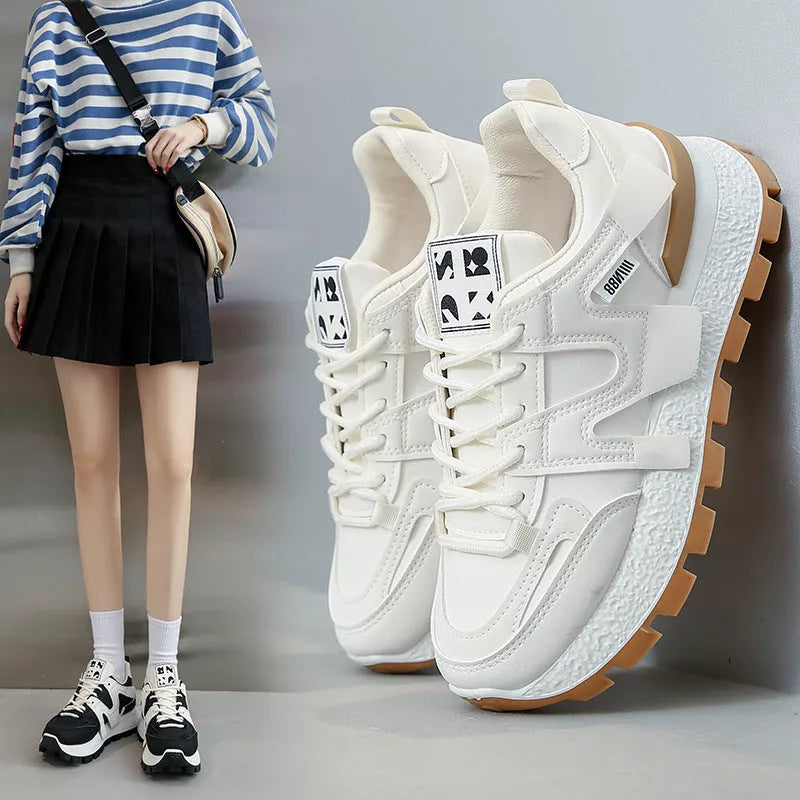 Women's low-top running sneaker in white or black with rubber sole