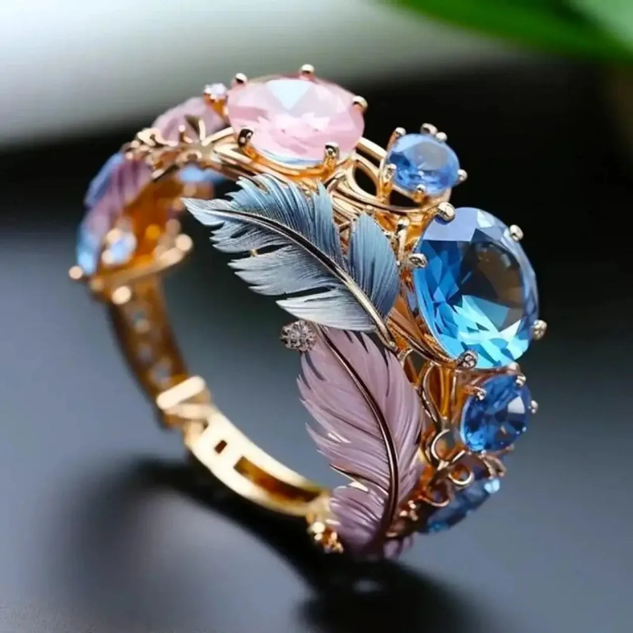 Gold colour brass feather ring with embossed geometric design and zircon inlays showing colourful pattern detail