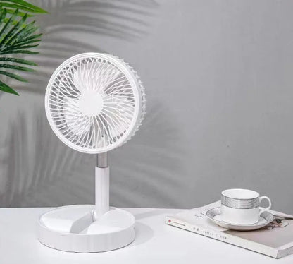 Black telescopic portable folding fan shown extended to full height on a desk, with control panel visible.