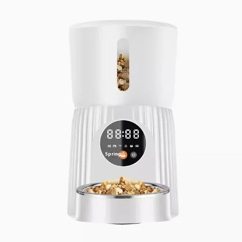 Black intelligent pet feeder with transparent food container showing kibble, digital display, and USB power cable