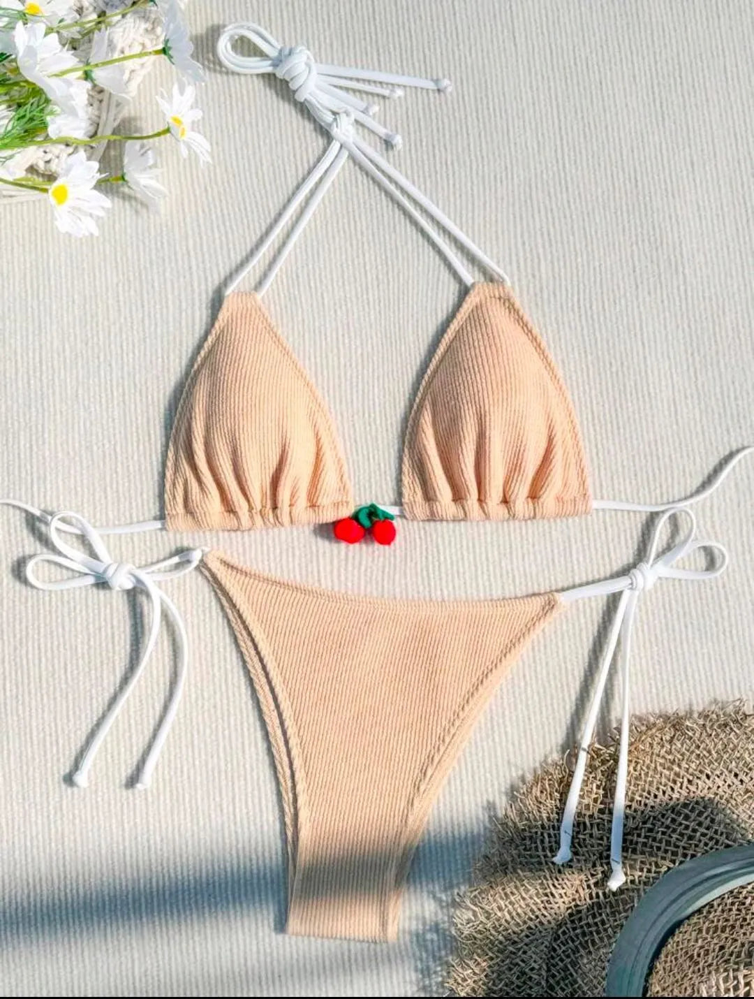 Solid colour briefs-style bikini swimsuit on a hanger, showing the top and pants.