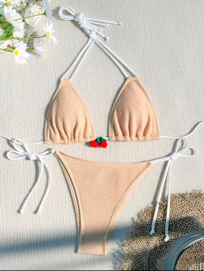 Solid colour briefs-style bikini swimsuit on a hanger, showing the top and pants.