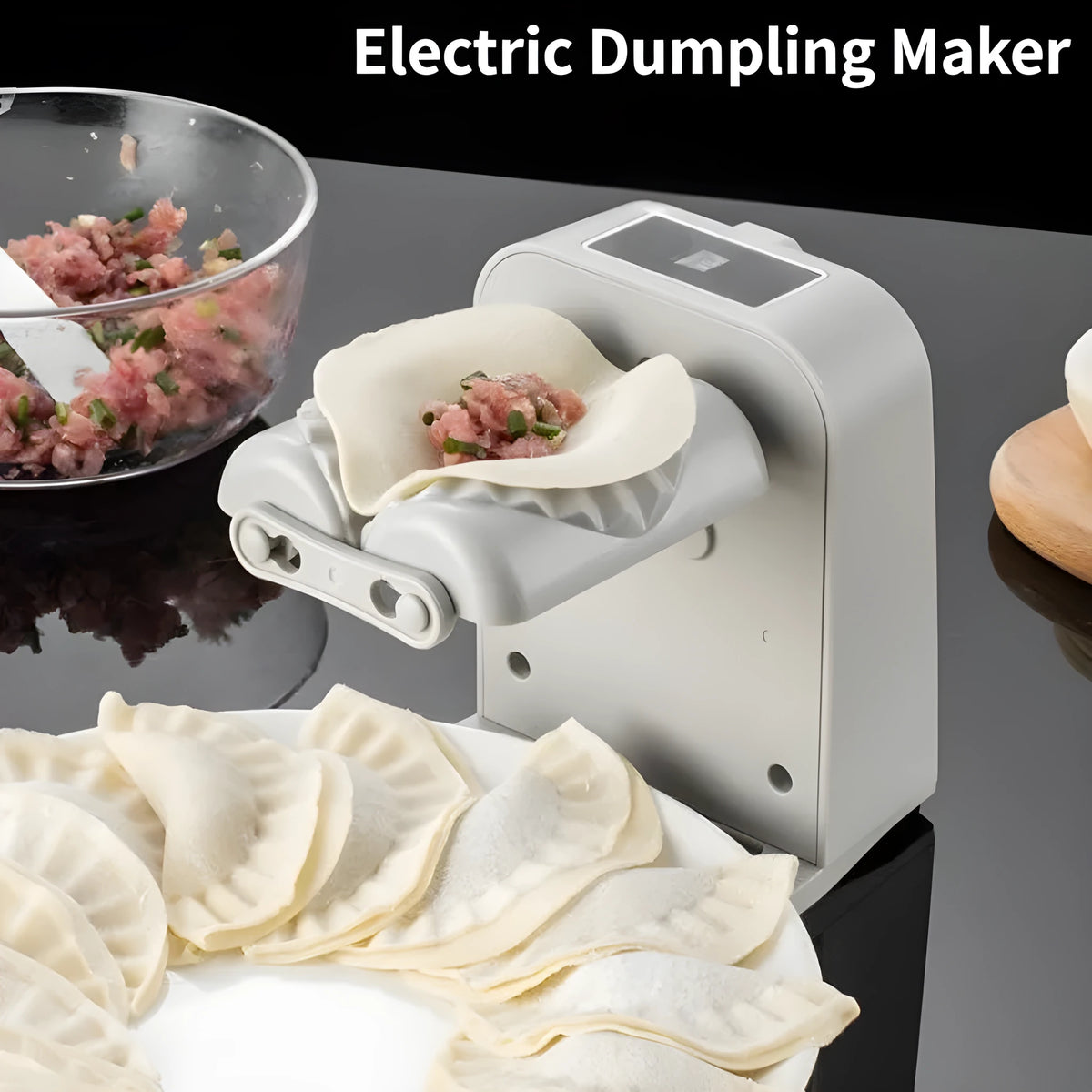 White automatic electric dumpling maker machine with USB cable, brush, and spoon.