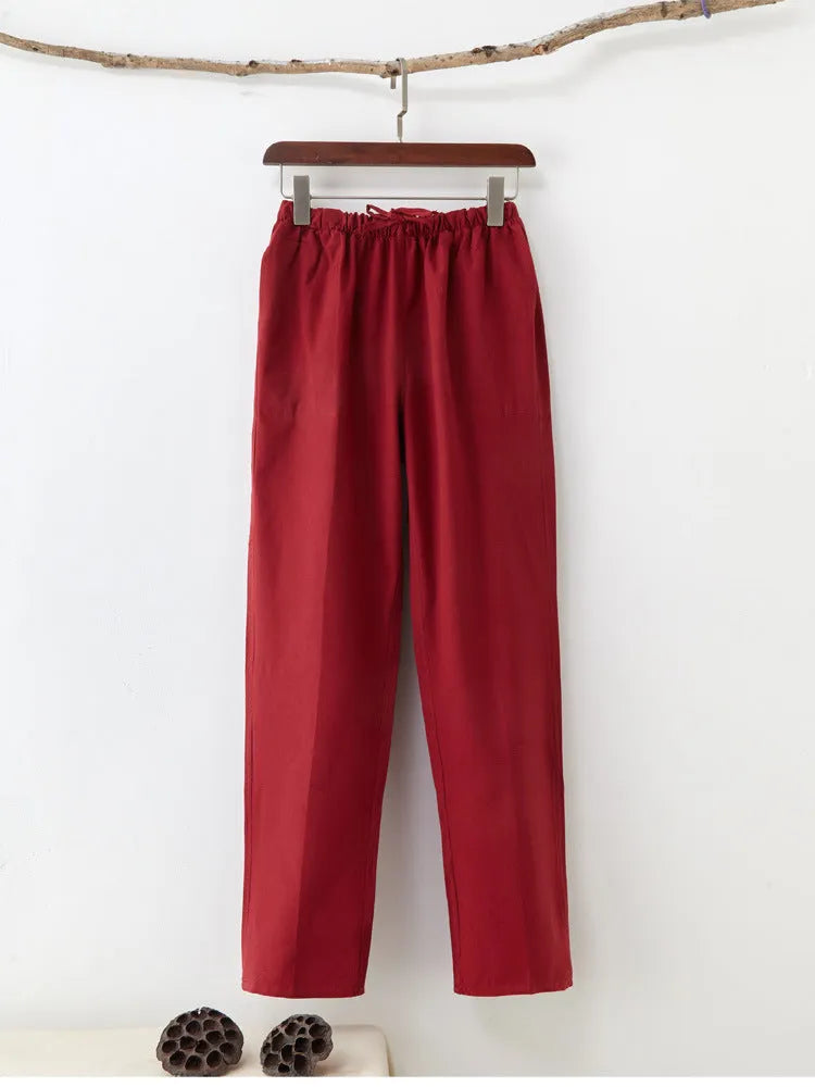 Men's beige pure cotton casual trousers with a drawstring waist on a mid-grey background.
