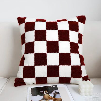 Black and white checkerboard square pillow measuring 45cm on sofa