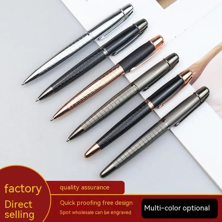 Gun grey metal rollerball pen with a metal barrel on a flat surface.