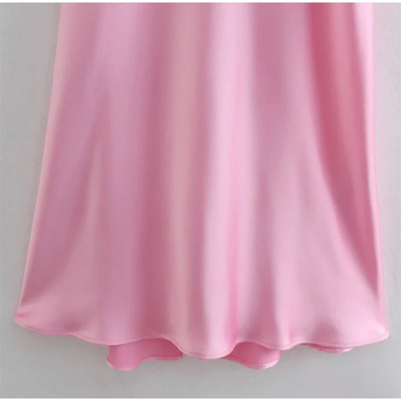 Elegant satin slip dress in pink with a flattering, form-fitting silhouette and sexy backless design