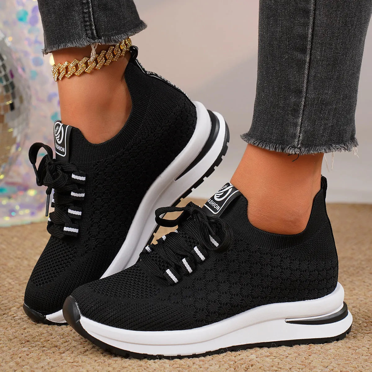 Women's black mesh lace-up platform sneakers with a round toe and flat rubber sole on a white background.