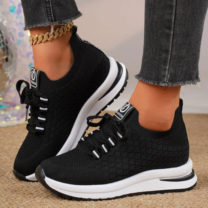 Women's black mesh lace-up platform sneakers with a round toe and flat rubber sole on a white background.