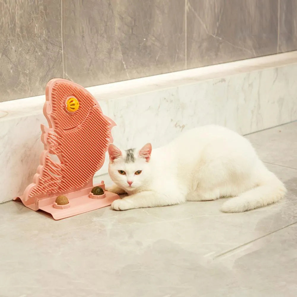 Blue fish-shaped cat wall scratcher with grooming brush, two catnip balls, and bell on white base