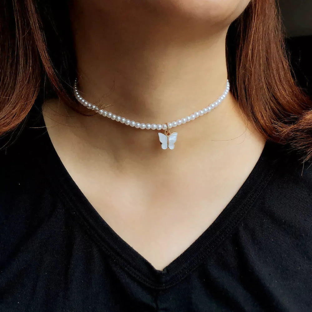 Elegant white pearl choker necklace with butterfly charm for women