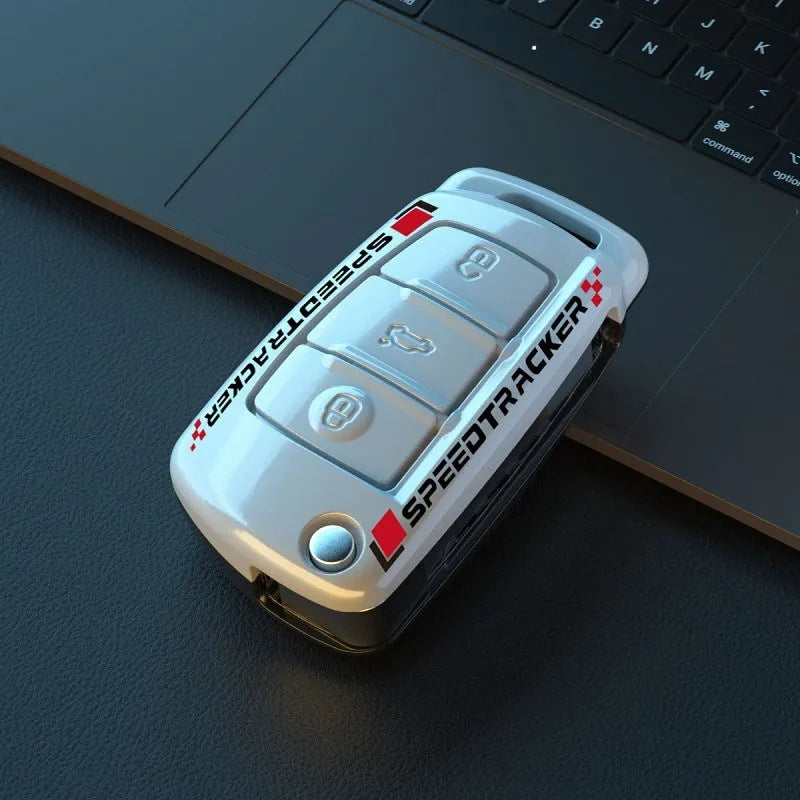 Carbon fibre style car key cover with a mirrored surface element, shown in black and white.