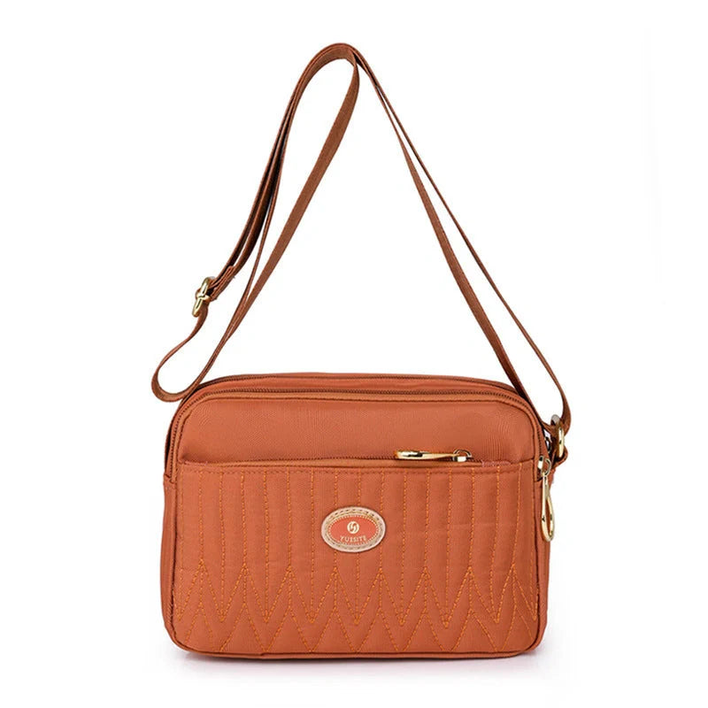 Casual women's crossbody messenger bag in nylon with polyester lining, available in multiple colors