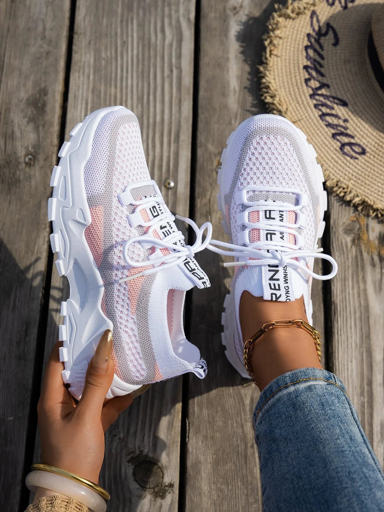 Women's Flyknit mesh lace-up sneakers in a grey colourway on a white background