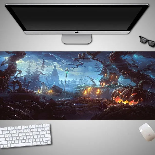 Halloween-themed oversized cloth mouse pad with non-slip rubber base on a wooden desk.
