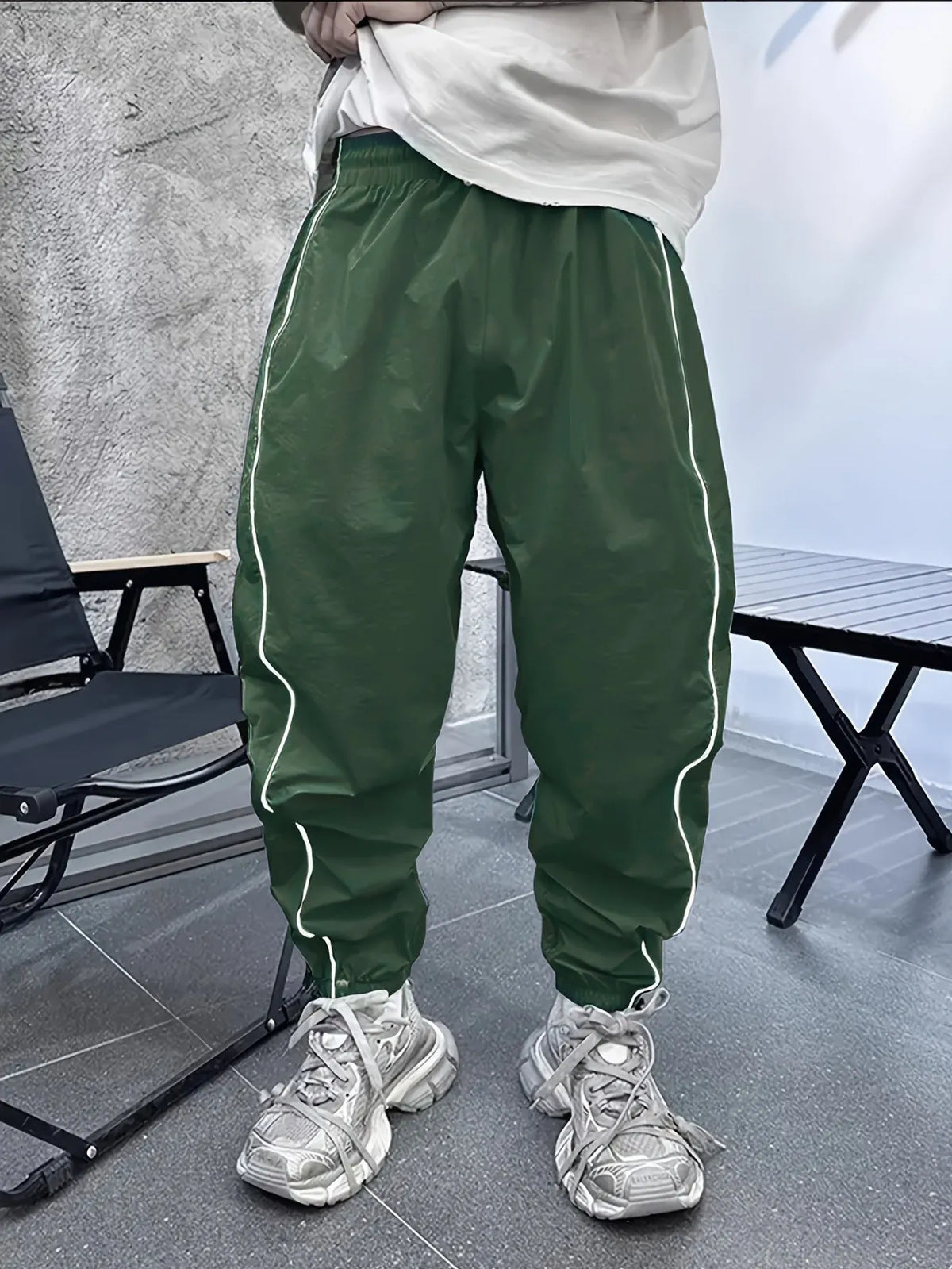 Men's bamboo fibre cropped sports trousers in army green colour showing loose fit and elastic waistband