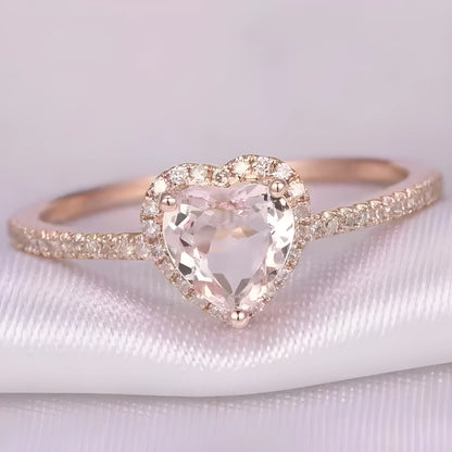 Women's heart-shaped crystal wedding ring in rose gold or silvery on a white background.