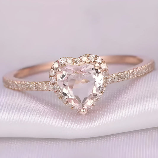 Women's heart-shaped crystal wedding ring in rose gold or silvery on a white background.
