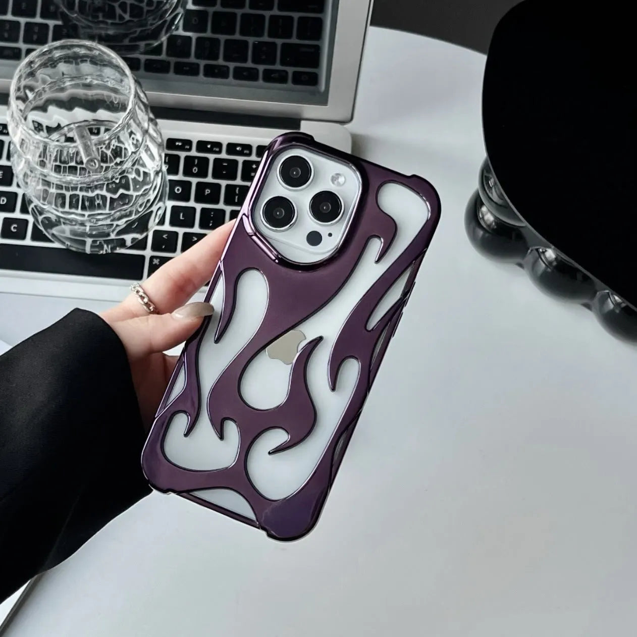 Electroplated hollow flame pattern phone case in silver plated finish on Apple iPhone, showing heat dissipation design and TPU soft shell