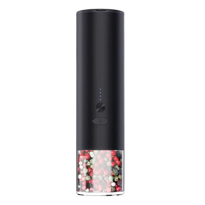 White electric salt and pepper grinder with stainless steel top and clear glass jar on a kitchen counter.