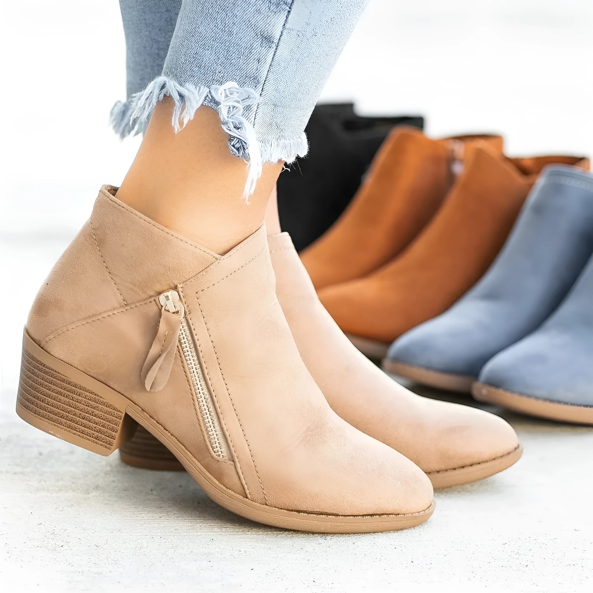 Women's blue suede Dr Martens ankle boots with side zip and chunky heel.