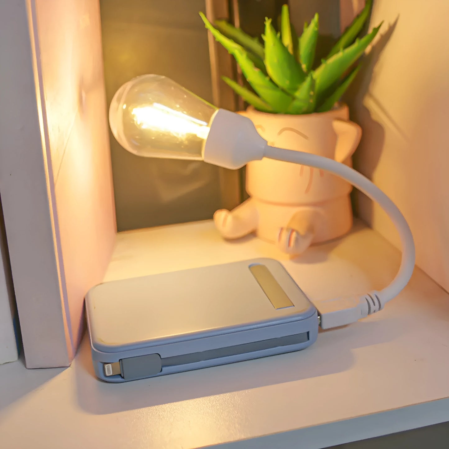 USB rechargeable folding night light with tungsten filament bulb showing warm white illumination