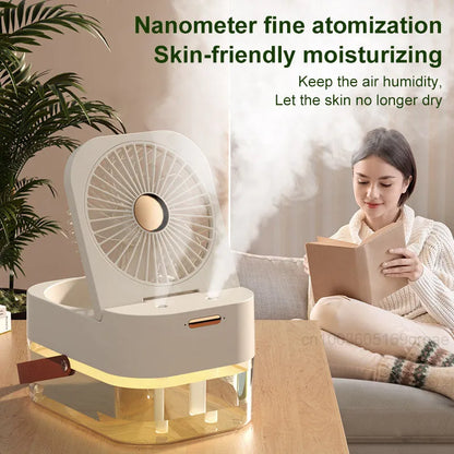 White or green USB desktop mist fan with large water tank, remote control, and dual spray nozzles on a desk.