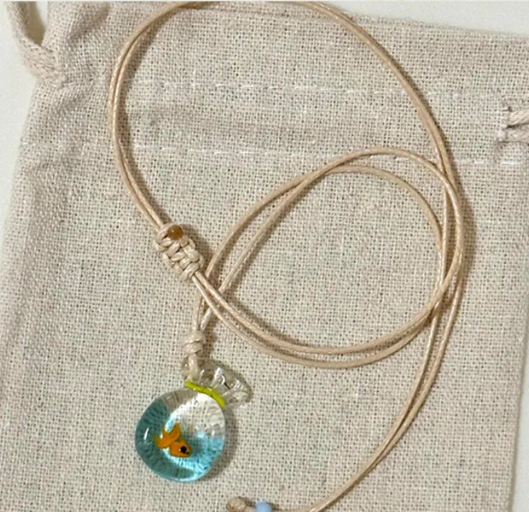 Women's necklace with coloured glaze pendant on a cotton-linen chain, showcasing world-style design