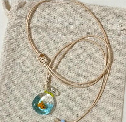 Women's necklace with coloured glaze pendant on a cotton-linen chain, showcasing world-style design