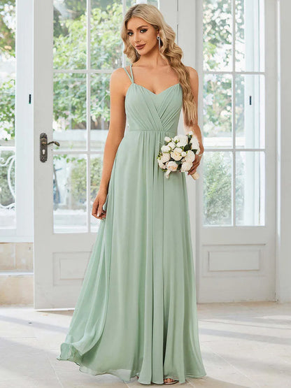Women's sleeveless long dress with sling neckline and pleated A-line skirt in a solid colour.