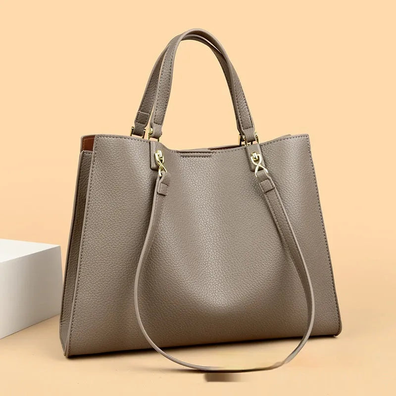 Women's horizontal square messenger tote bag in PU leather with crossbody strap and internal compartments.