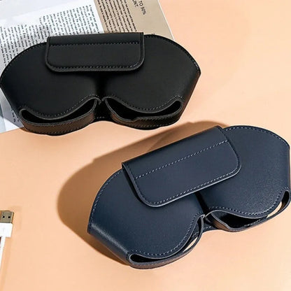 Black PU leather protective case for Apple AirPods Max headphones on a table.