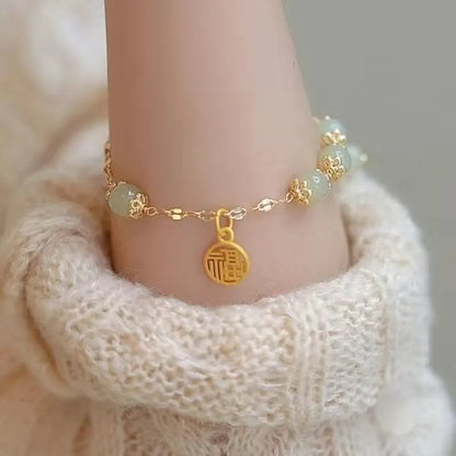 Chinese style glass bead bracelet with bamboo joint design on wrist.