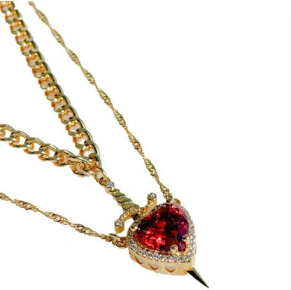 Fashionable Heart and Sword Pendant Necklace Set made of stainless steel with sparkling crystals for a bold, romantic look