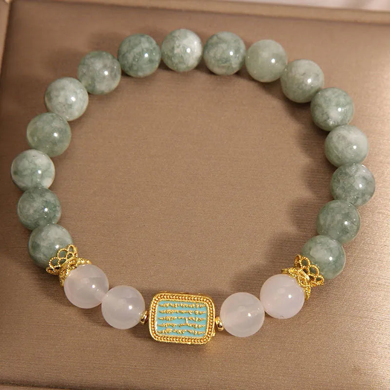 Women's bracelet with five oil green emerald crystal stones in a scripture charm design.
