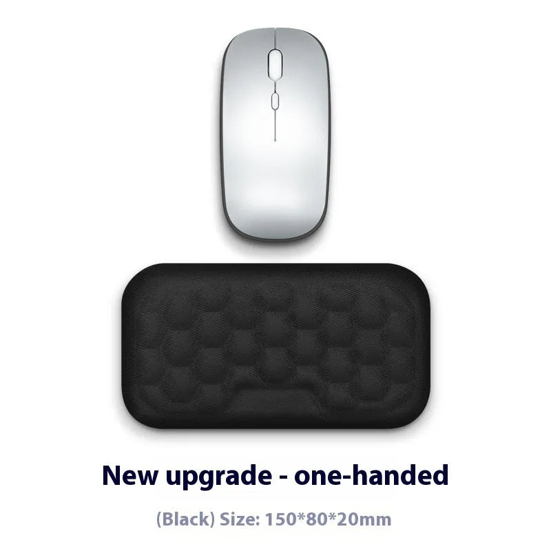 Black and grey memory foam mouse wrist rests with cloth and leather-style covers on a desk.