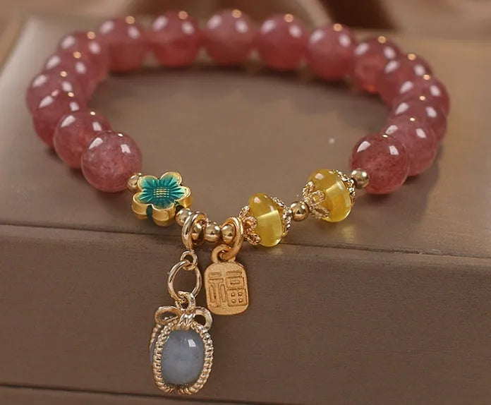 Red women's bracelet with strawberry quartz beads and rhinestones on an alloy chain.