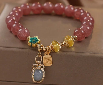 Red women's bracelet with strawberry quartz beads and rhinestones on an alloy chain.