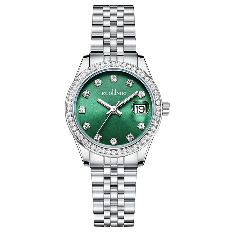 Women's silver alloy calendar watch with quartz movement and stainless steel buckle on wrist.