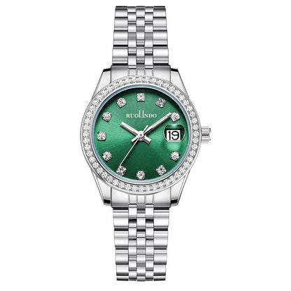 Women's silver alloy calendar watch with quartz movement and stainless steel buckle on wrist.