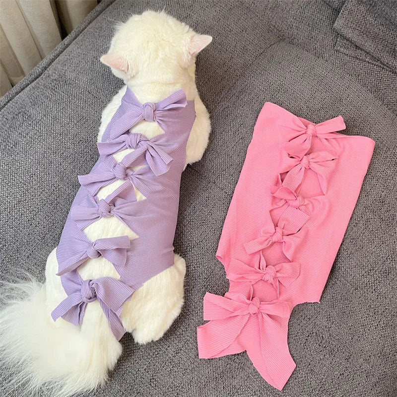 Lace-up cat sterilisation clothing in five colours including pink, purple, blue, brown, and green pineapple, showing adjustable fastening