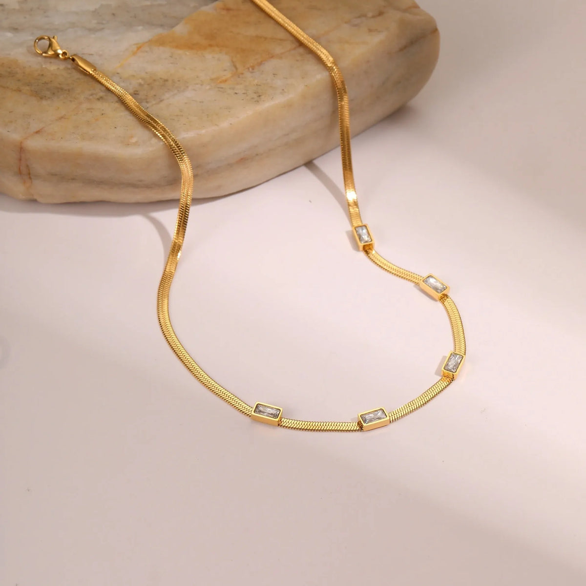 Retro geometric square zircon necklace with stainless steel construction and 18K gold plating on flat snake chain