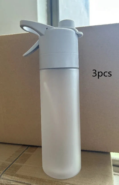 Large plastic spray water bottle with handle strap and leakproof lid in green colour.