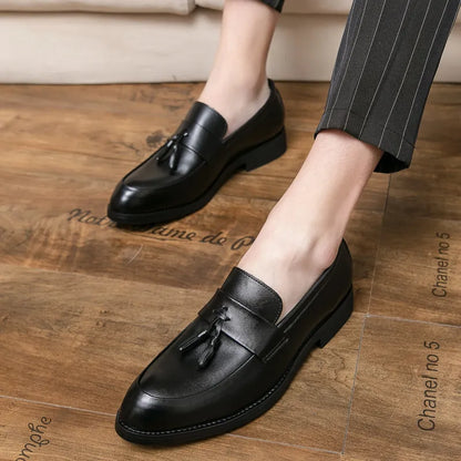 Men's black and brown business casual slip-on shoes with tassel detail and pointed toe